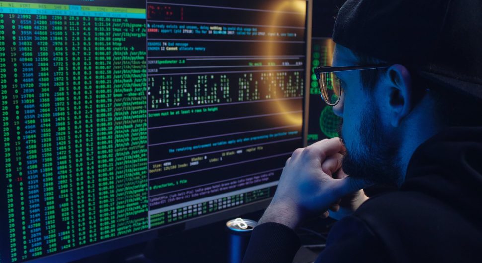 Free A Man Looking at a Computer Screen with Data Stock Photo
